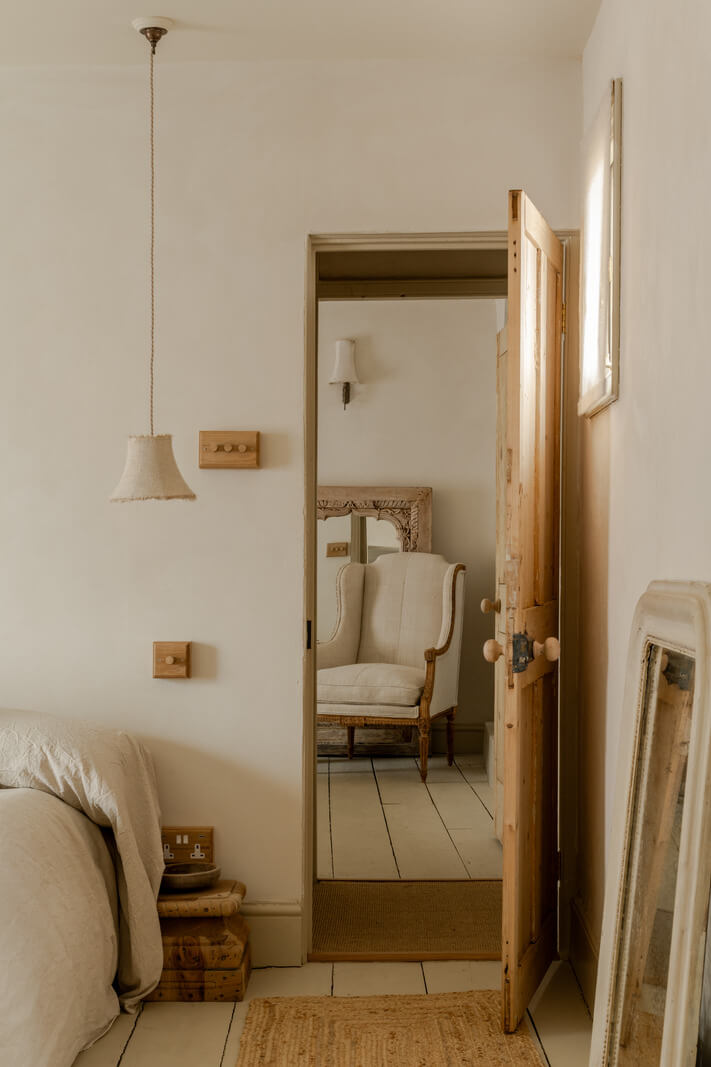 A Light Rustic Farmhouse-Style in an English Cottage 17 serene bedroom with wooden floorboards and light color palette nordroom