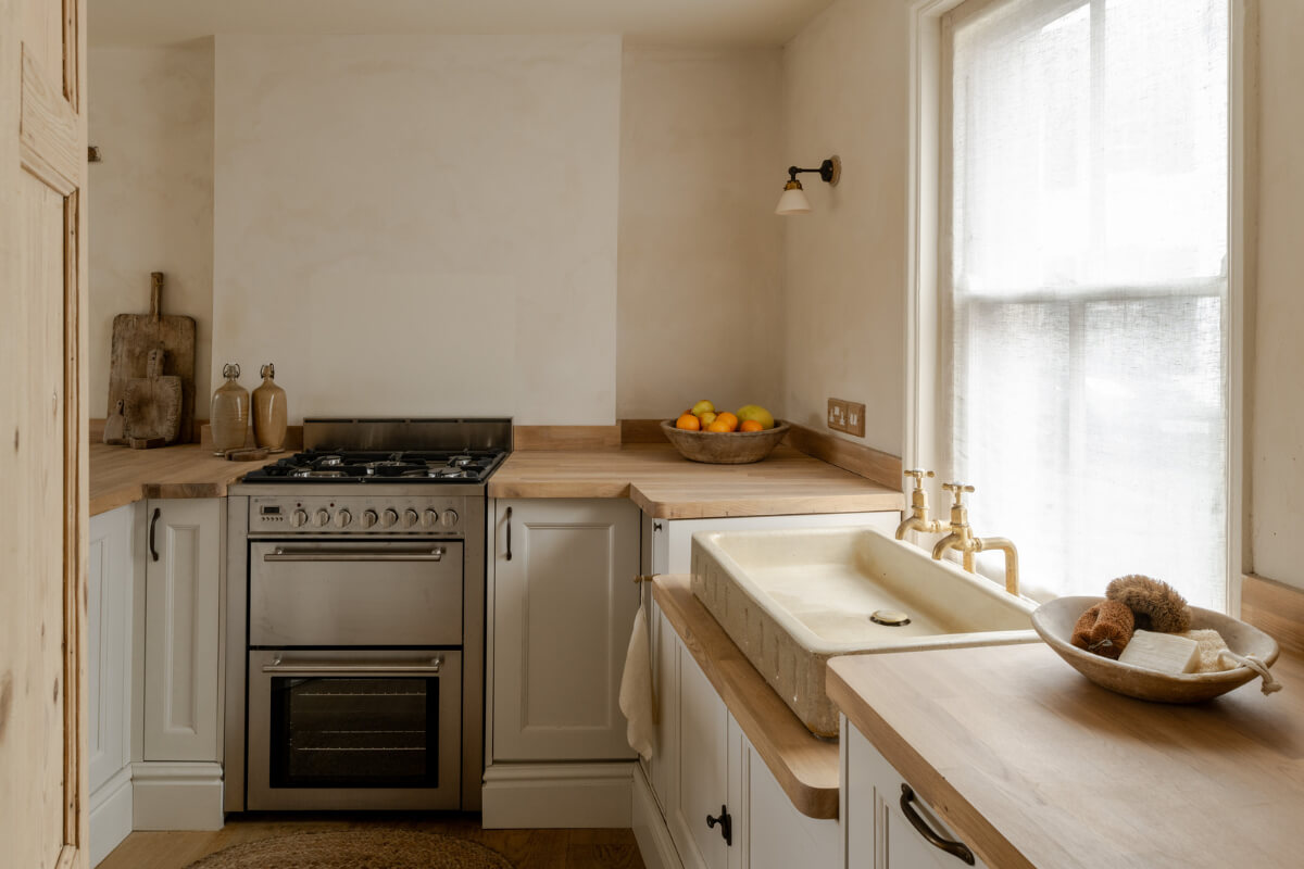 A Light Rustic Farmhouse-Style in an English Cottage 12 serene cottage style kitchen with light gray cabinets and sink under window nordroom
