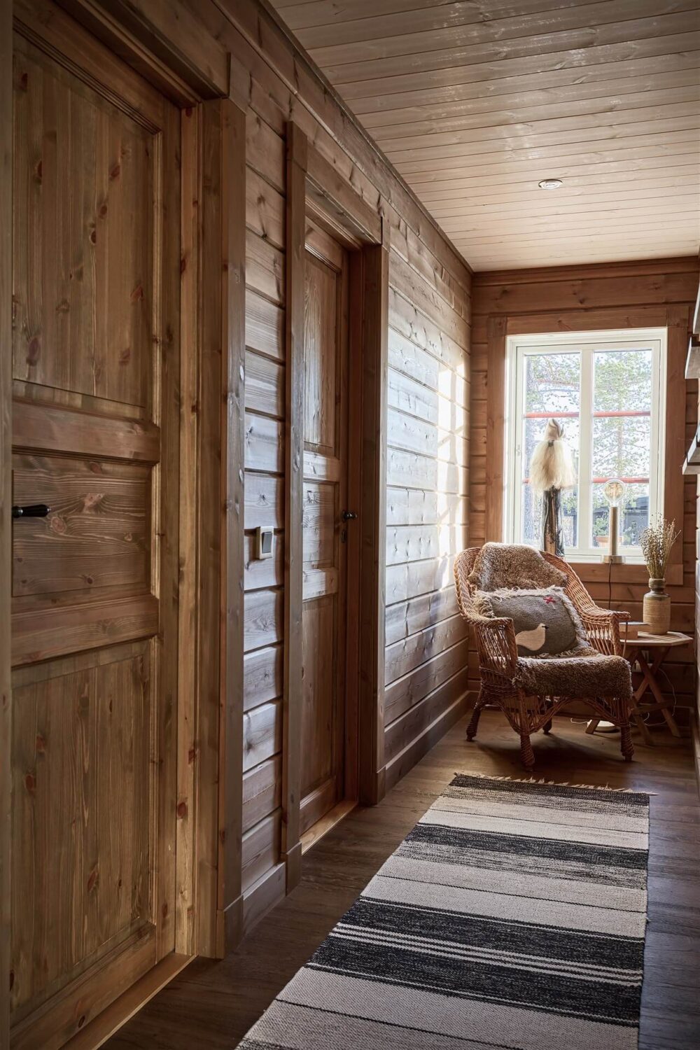 A Warm and Inviting Mountain House in Sweden 11 sitting nook in front of the window A Warm and Inviting Mountain House in Sweden