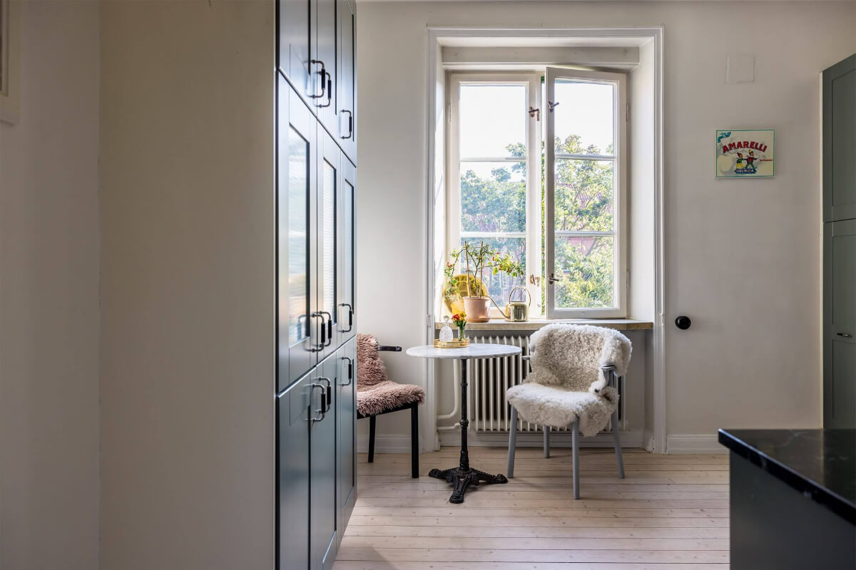 A Spacious Nordic Apartment with a Wonderful Color Palette 18 small round kitchen table in front of the window