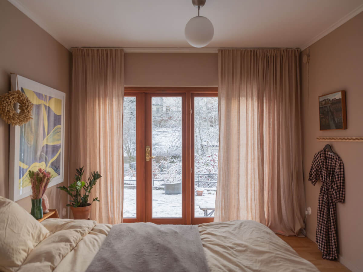 A Beautiful Midcentury Family Home South of Stockholm 19 soft colored bedroom with garden access