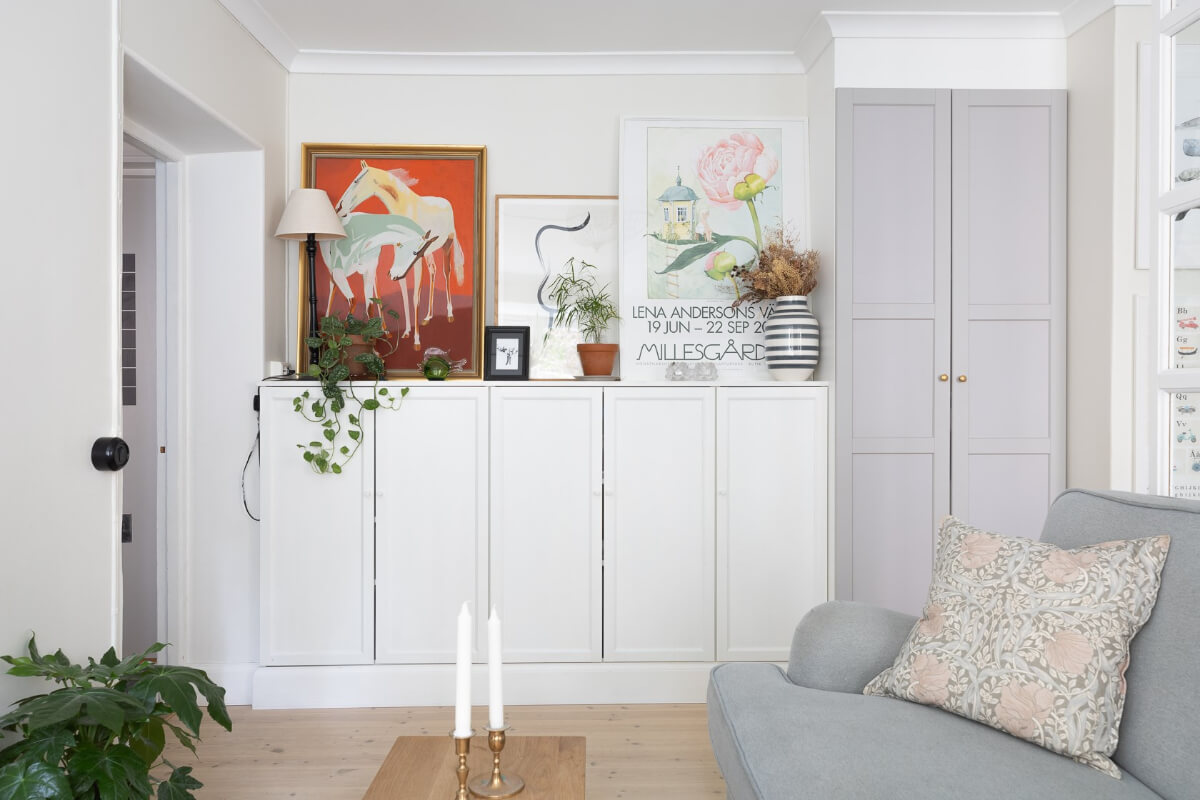 A Small and Bright Two-Bedroom Apartment in Stockholm 5 tiny light living room with built in cabinets and art