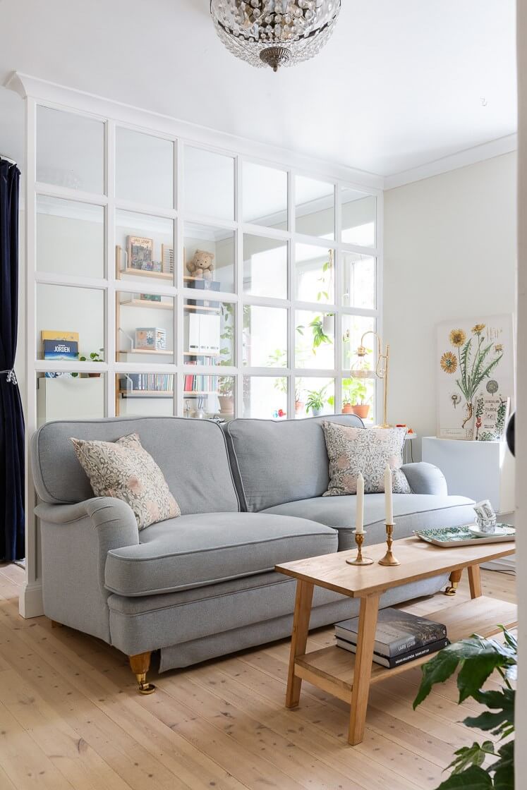 A Small and Bright Two-Bedroom Apartment in Stockholm 3 tiny living room with wooden floor and gray couch