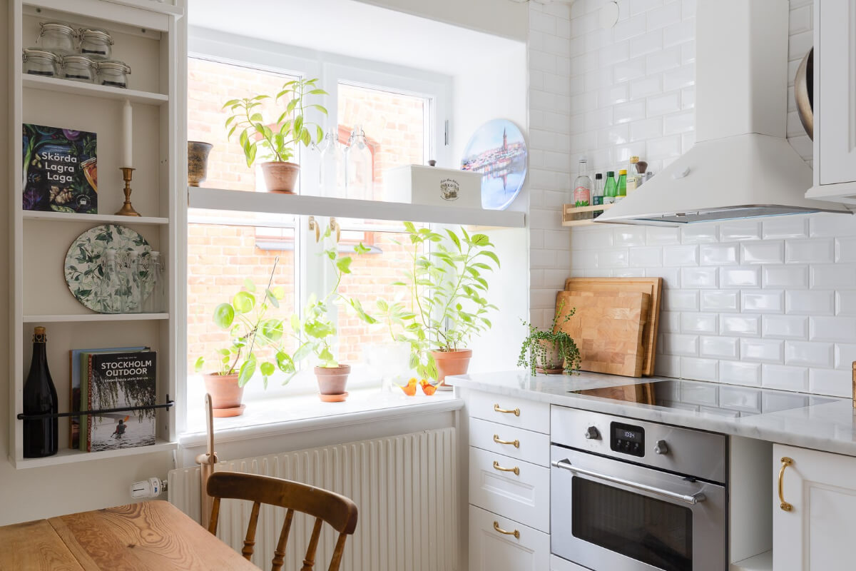 Small Space, Big Style: How to Design a Teeny-Tiny Kitchen That Works 12 tiny white kitchen with shelf in front of window
