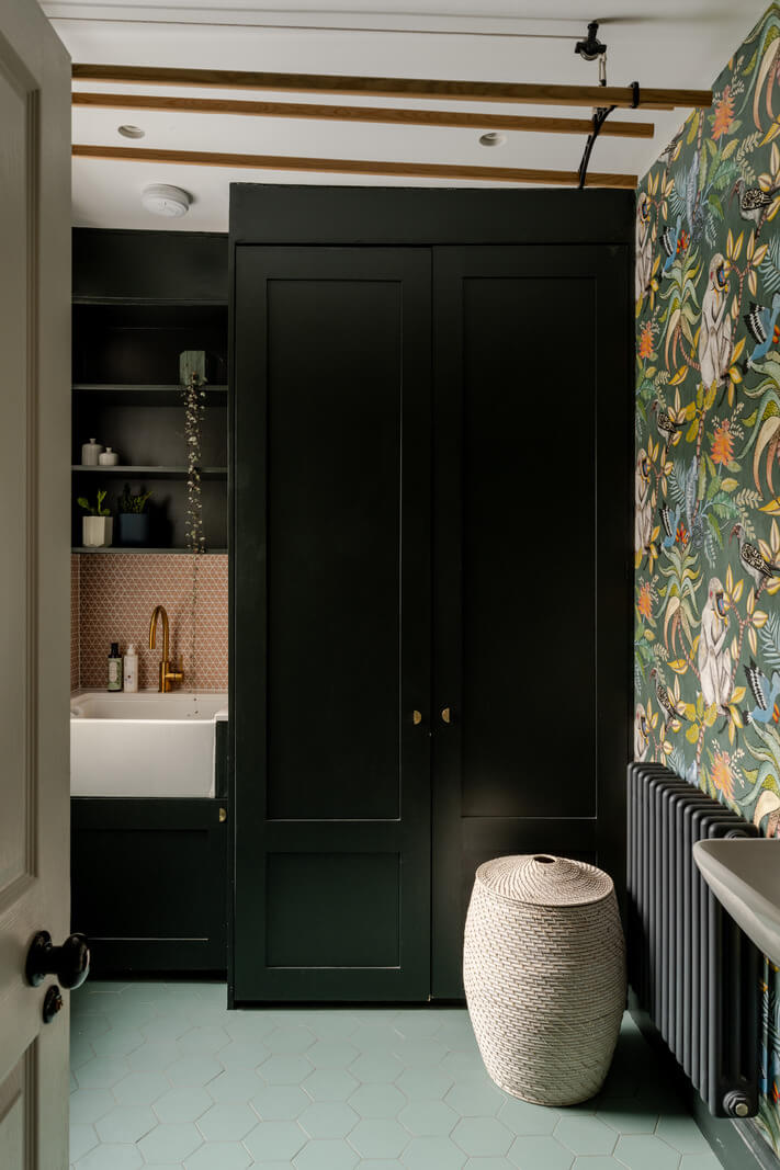 A Beautiful Extended Victorian Family Home in London 8 utility room with wallpaper and black cabinets