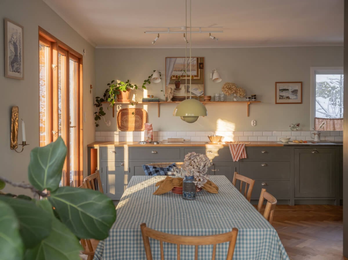 A Beautiful Midcentury Family Home South of Stockholm 10 warm kitchen with gray cabinets and wooden worktop