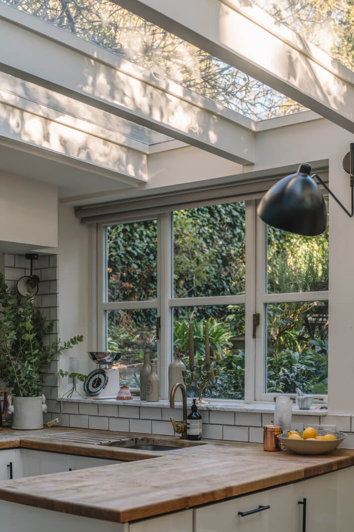 A Charming Garden Apartment in North Kensington 10 white kitchen with wooden worktop and skylights