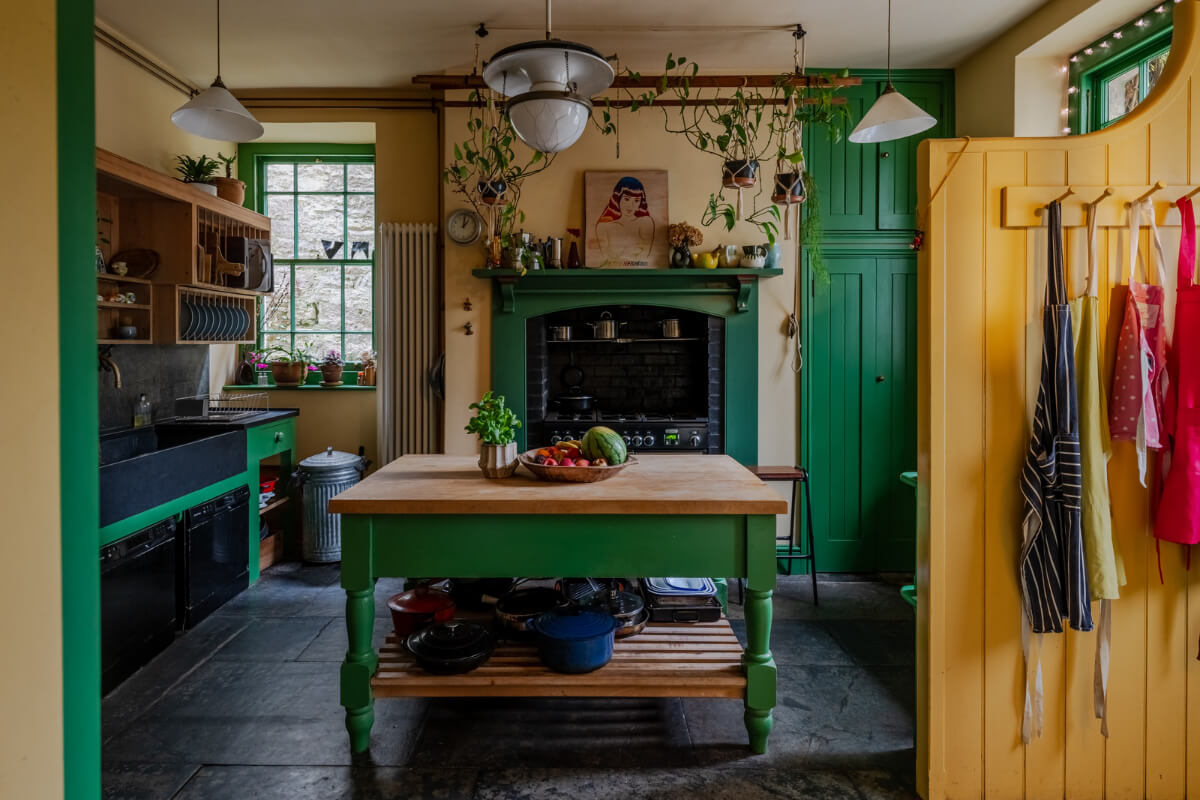 A Strong Color Palette in a Unique Country House in Cornwall 1 yellow and green kitchen with stone floor nordroom
