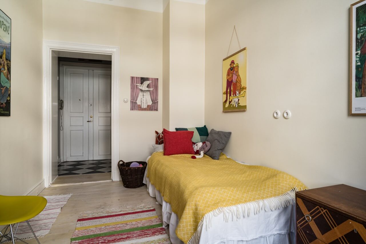 Muted Tones, Art, and Books in a Charming Stockholm Apartment 14 yellow bedroom