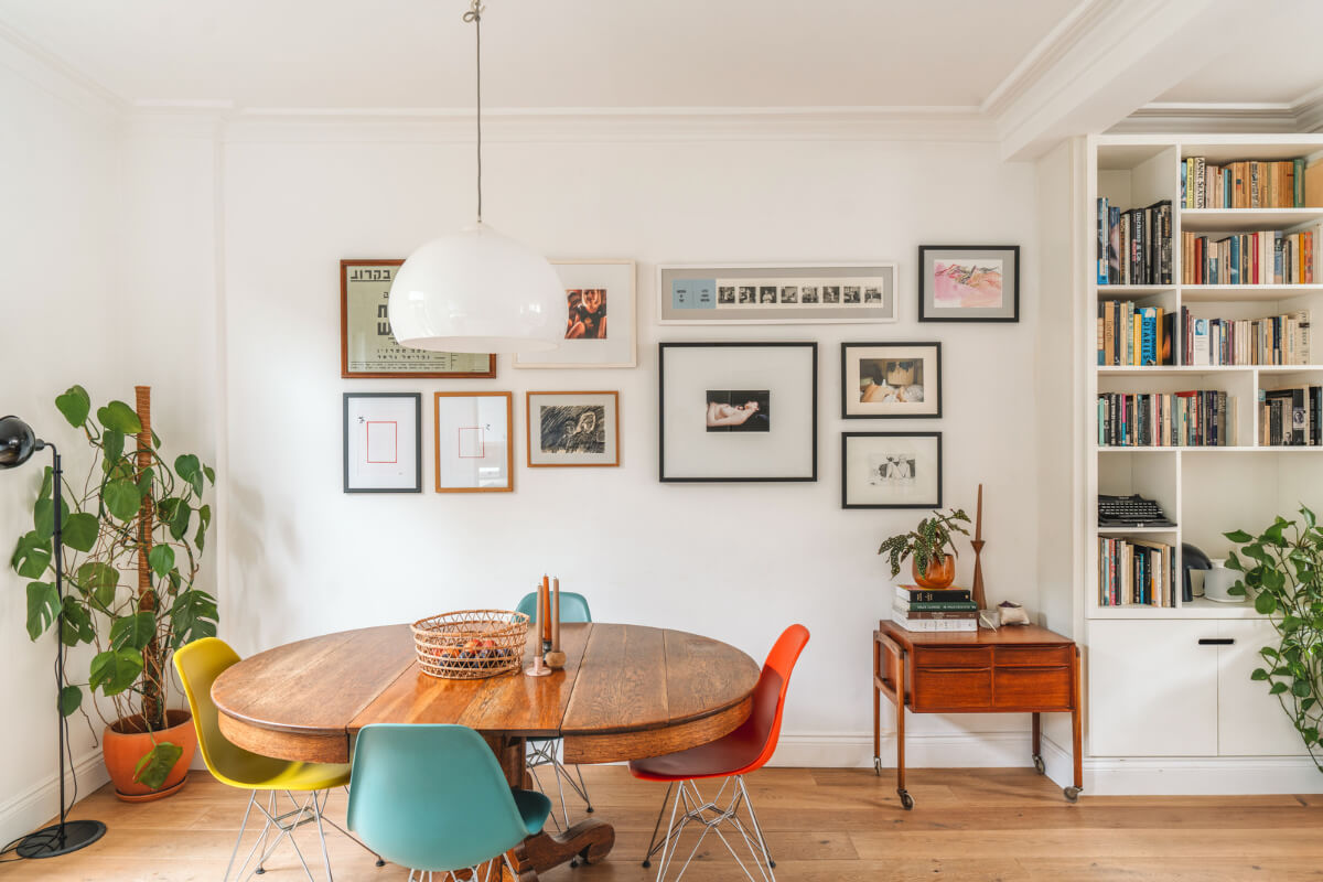 A Charming Light Edwardian House with a Tiny Garden 6 antique dining table colorful eames chairs