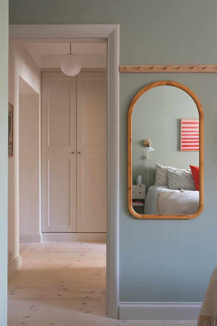 Modern Interiors in a Bright 1930s Apartment in Sweden 27 arched bedroom mirror