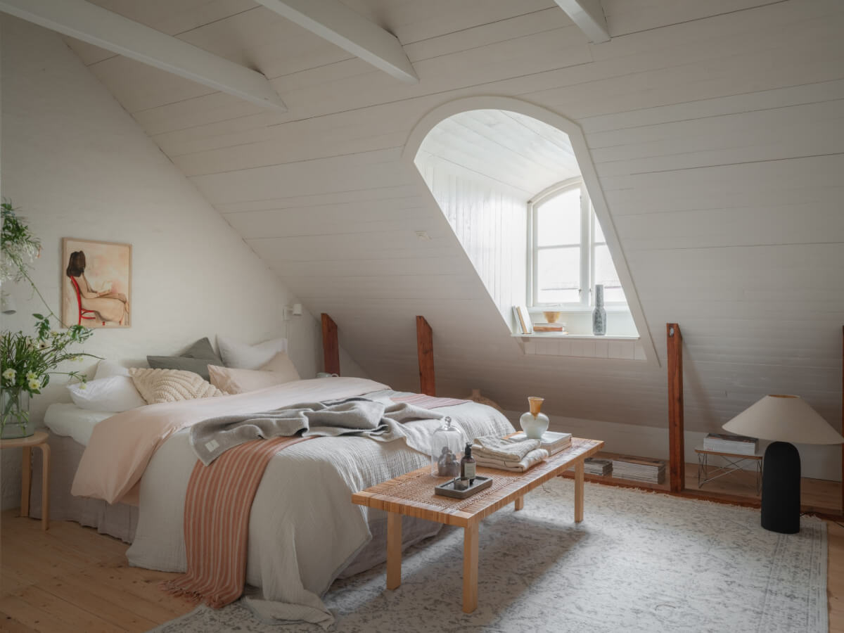 A Renovated Duplex Apartment with Exposed Brick Walls 17 attic bedroom dormer window exposed beams
