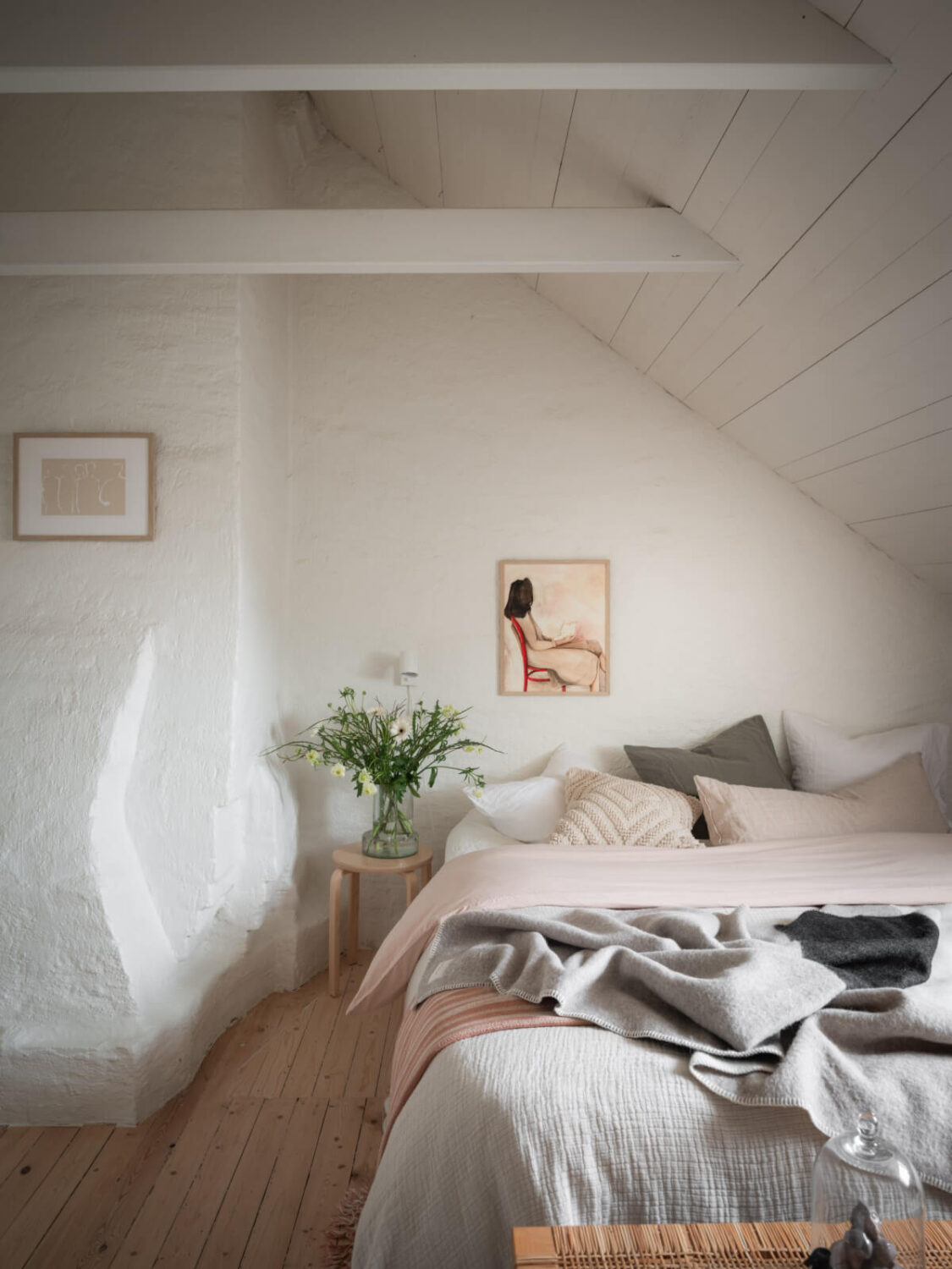 A Renovated Duplex Apartment with Exposed Brick Walls 19 attic bedroom pitched roof wooden beams