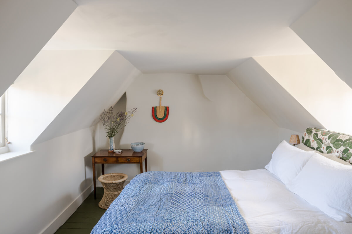 A Carefully Selected Color Palette in an 18th-Century English Cottage 15 attic bedroom with blue throw