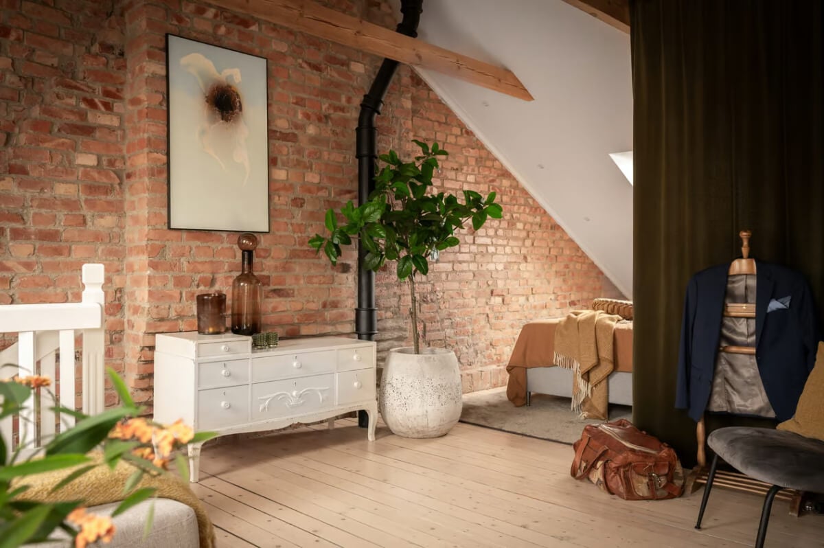 A Swedish Attic Apartment with Exposed Brick and Yellow Color Accents 17 attic bedroom with exposed brick wall