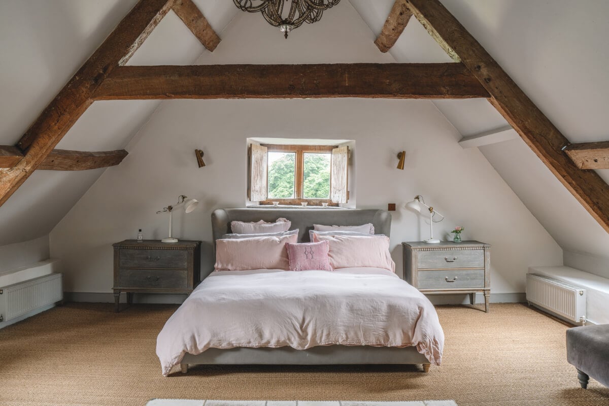 A Beautiful Renovated Country House in England 20 attic bedroom with exposed wooden beams