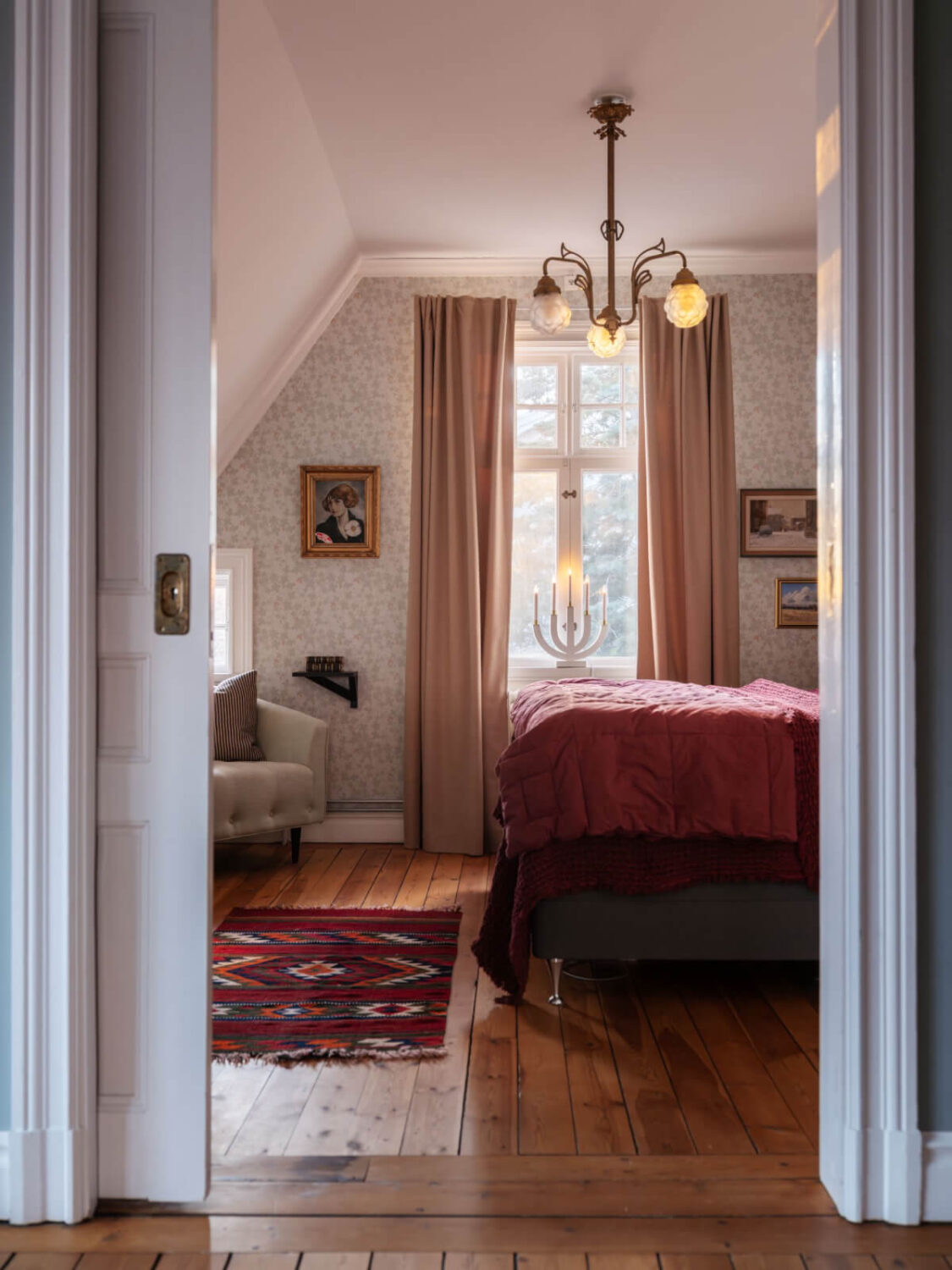 A Beautiful Turn-of-the-Century Family Home in Sweden 35 attic bedroom wooden floorboards wallpaper