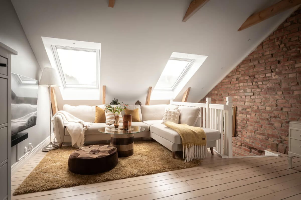 A Swedish Attic Apartment with Exposed Brick and Yellow Color Accents 12 attic living room exposed brick wall ochre yellow rug
