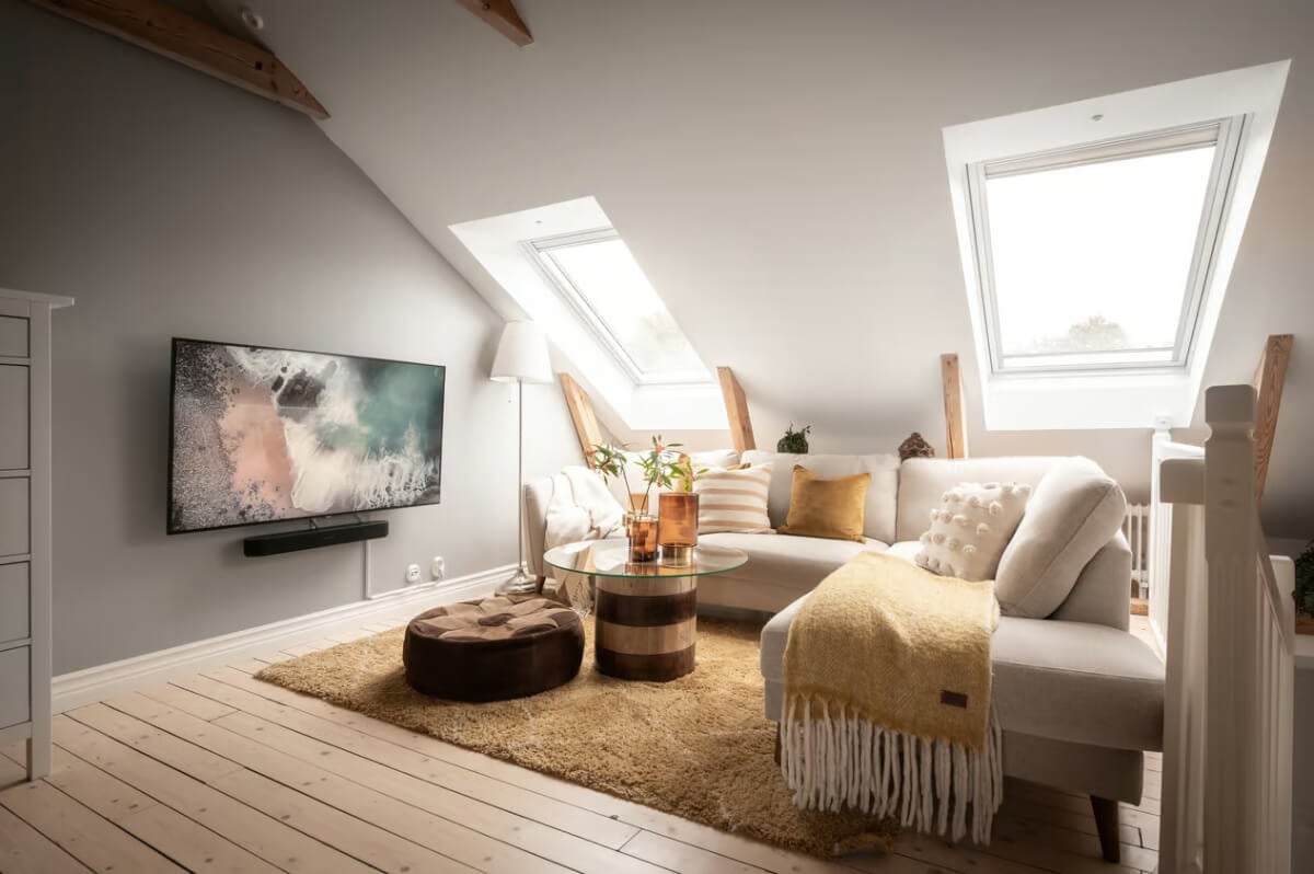 A Swedish Attic Apartment with Exposed Brick and Yellow Color Accents 13 attic living room gray accent wall ochre rug wooden floorboards
