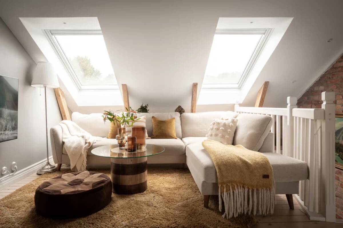 A Swedish Attic Apartment with Exposed Brick and Yellow Color Accents 15 attic living room large ochre rug
