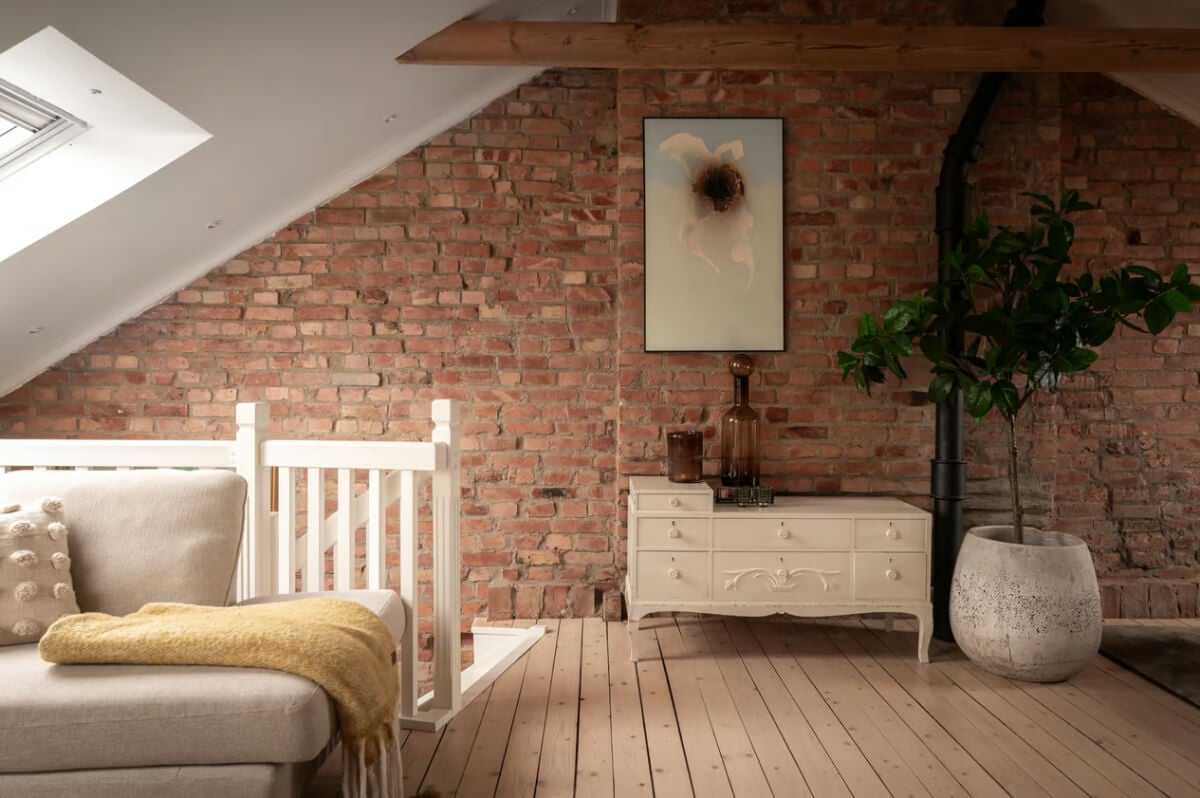 A Swedish Attic Apartment with Exposed Brick and Yellow Color Accents 16 attic room exposed brick wall wooden floorboards