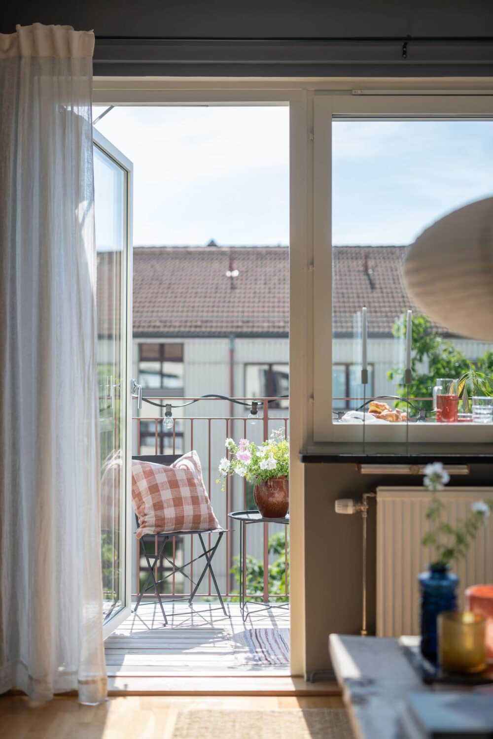 Light Rooms and a Moody Color Palette in a 1930s Apartment 8 balcony door