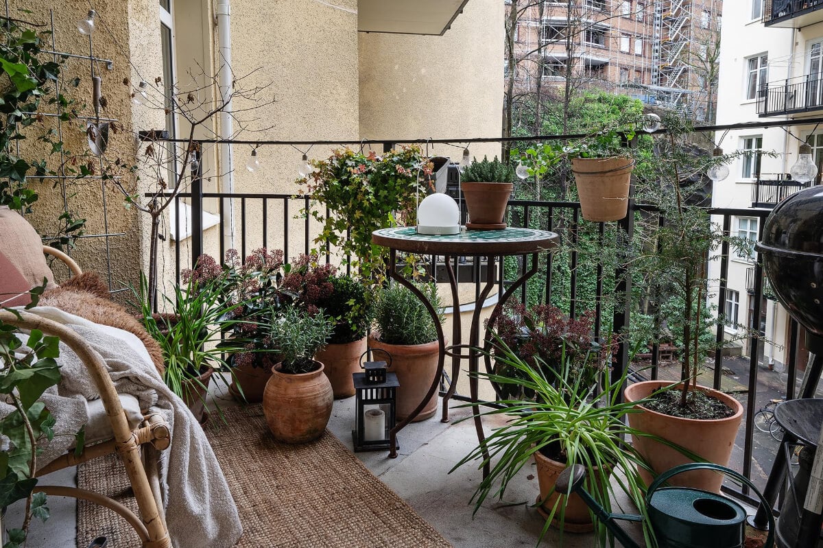 Period Features and Modern Materials in a Swedish Apartment 24 balcony with plants
