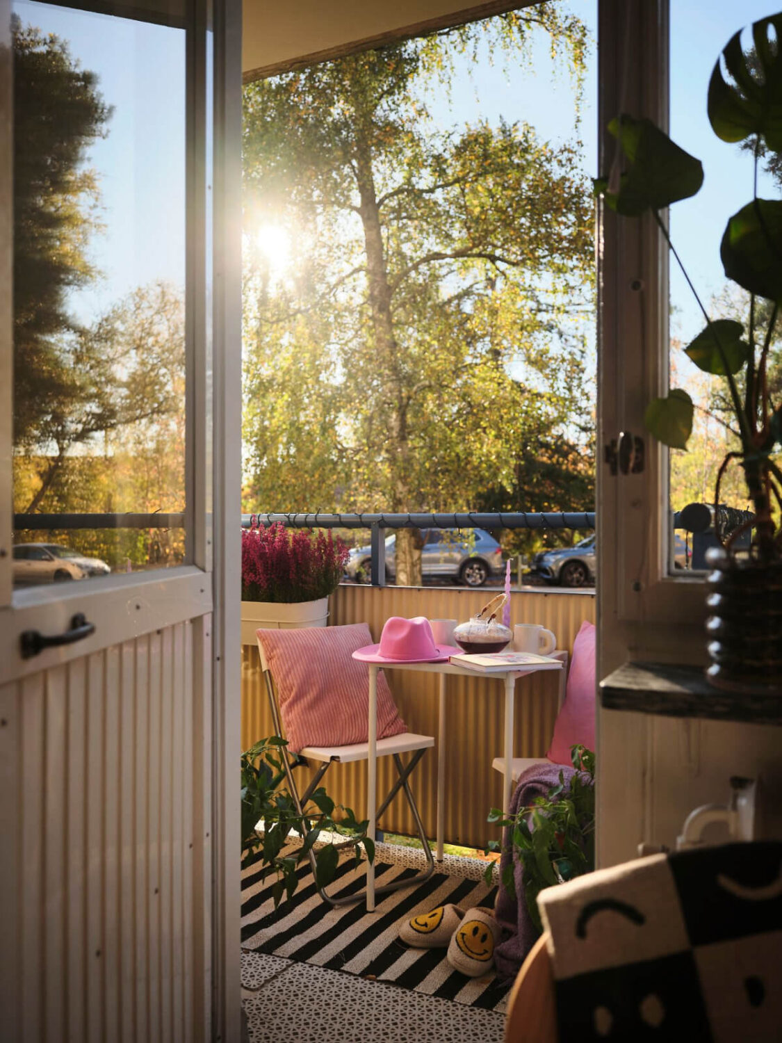 A Midcentury Swedish Apartment with Bright Color Accents 5 balcony with striped rug