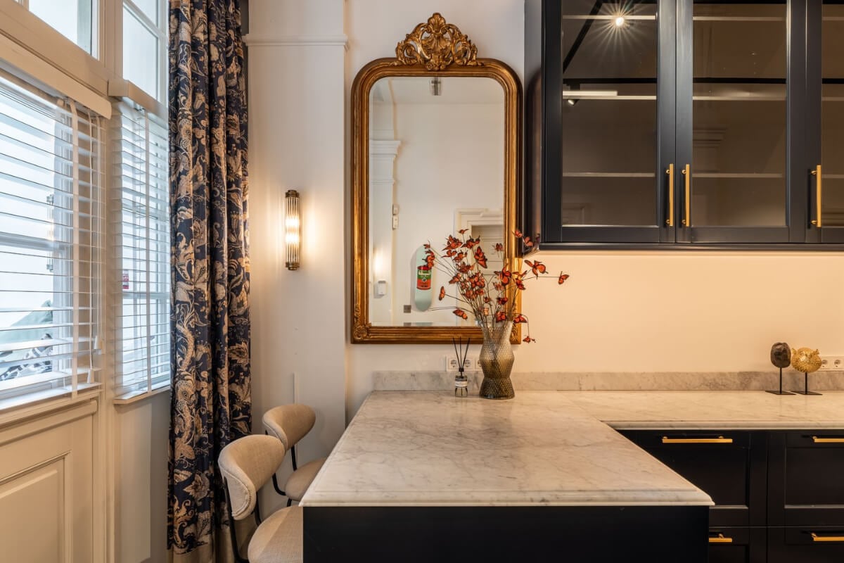 A Unique Ground Floor Duplex Apartment in Amsterdam 3 bar seating dark blue kitchen marble countertop