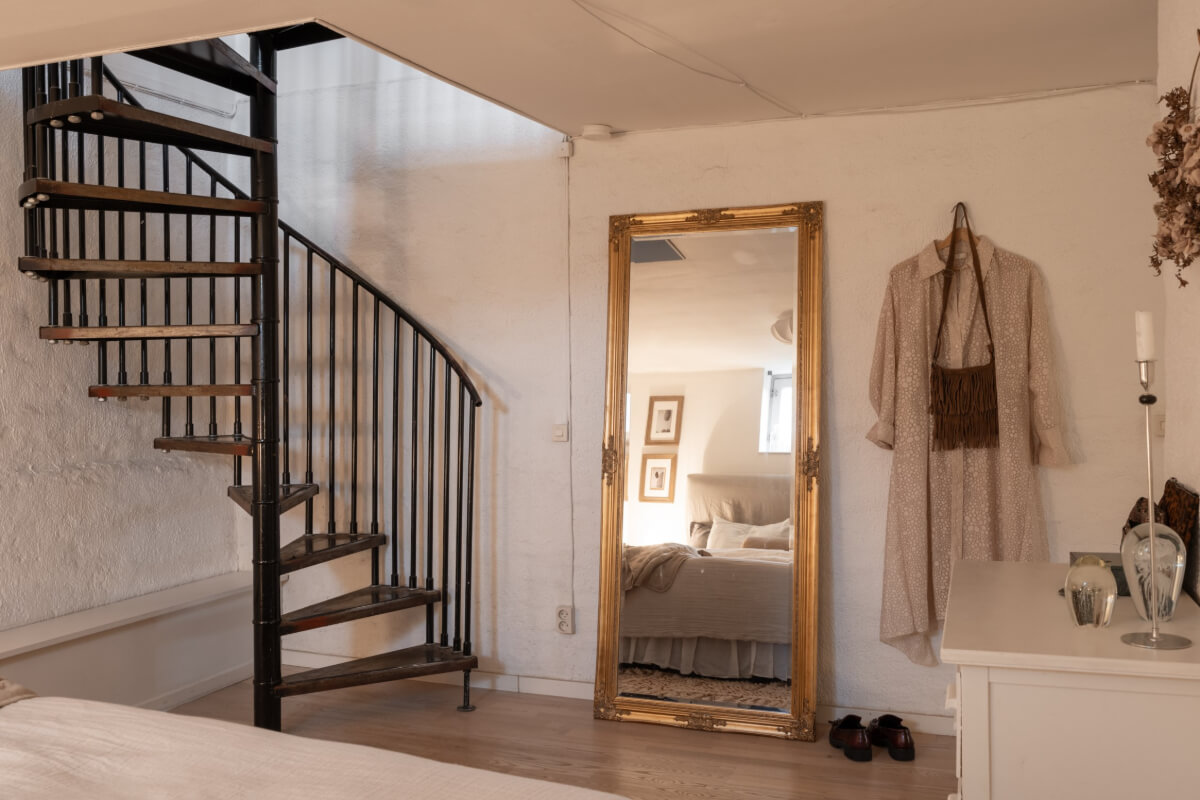A Swedish Maisonette Apartment with Basement Bedrooms 21 basement bedroom gilded mirro