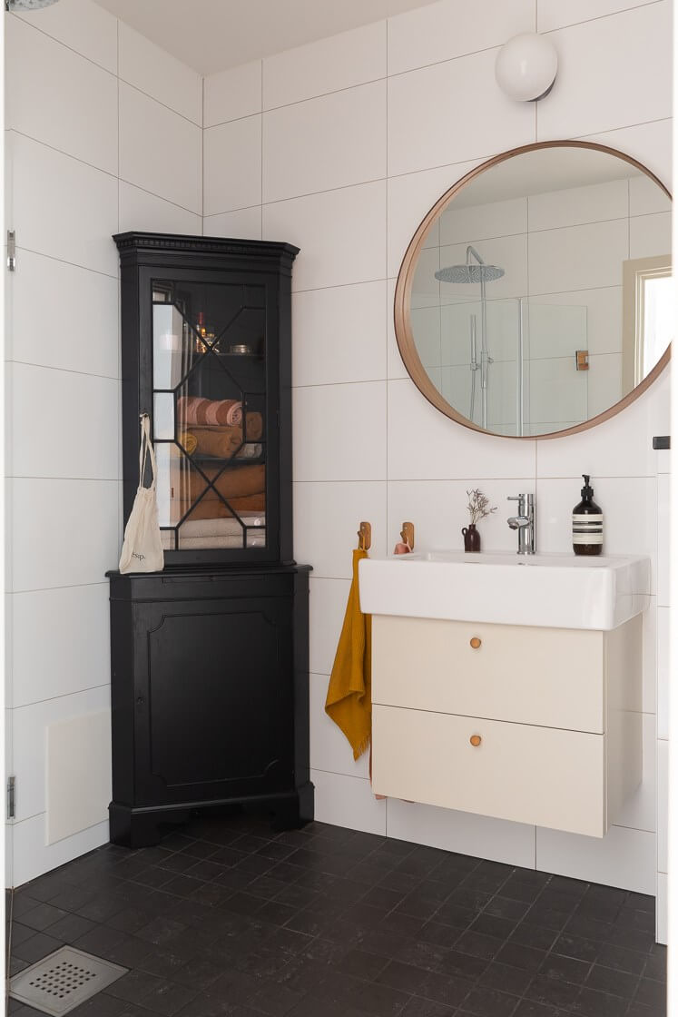 Modern Interiors in a Bright 1930s Apartment in Sweden 33 bathroom black corner cabinet