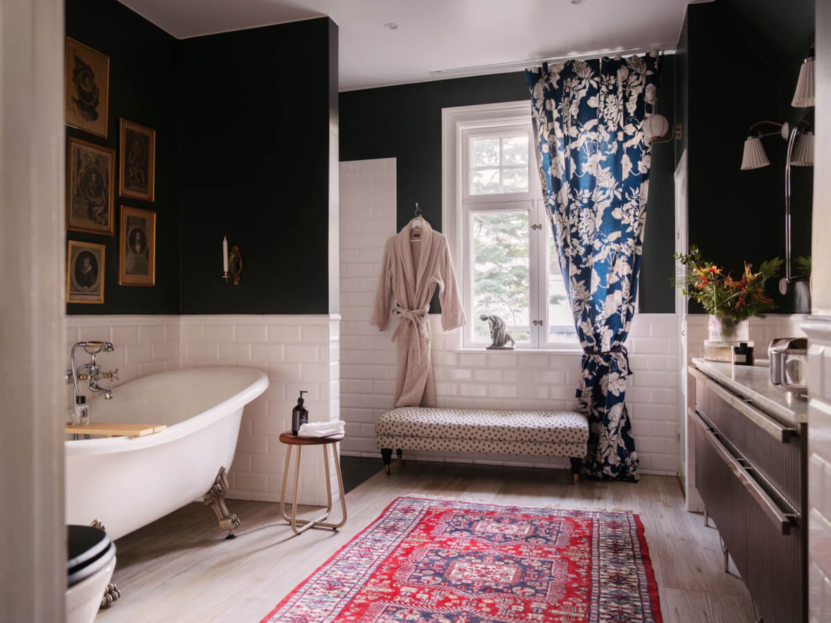 A Beautiful Turn-of-the-Century Family Home in Sweden 38 bathroom dark walls white tiles freestanding bath
