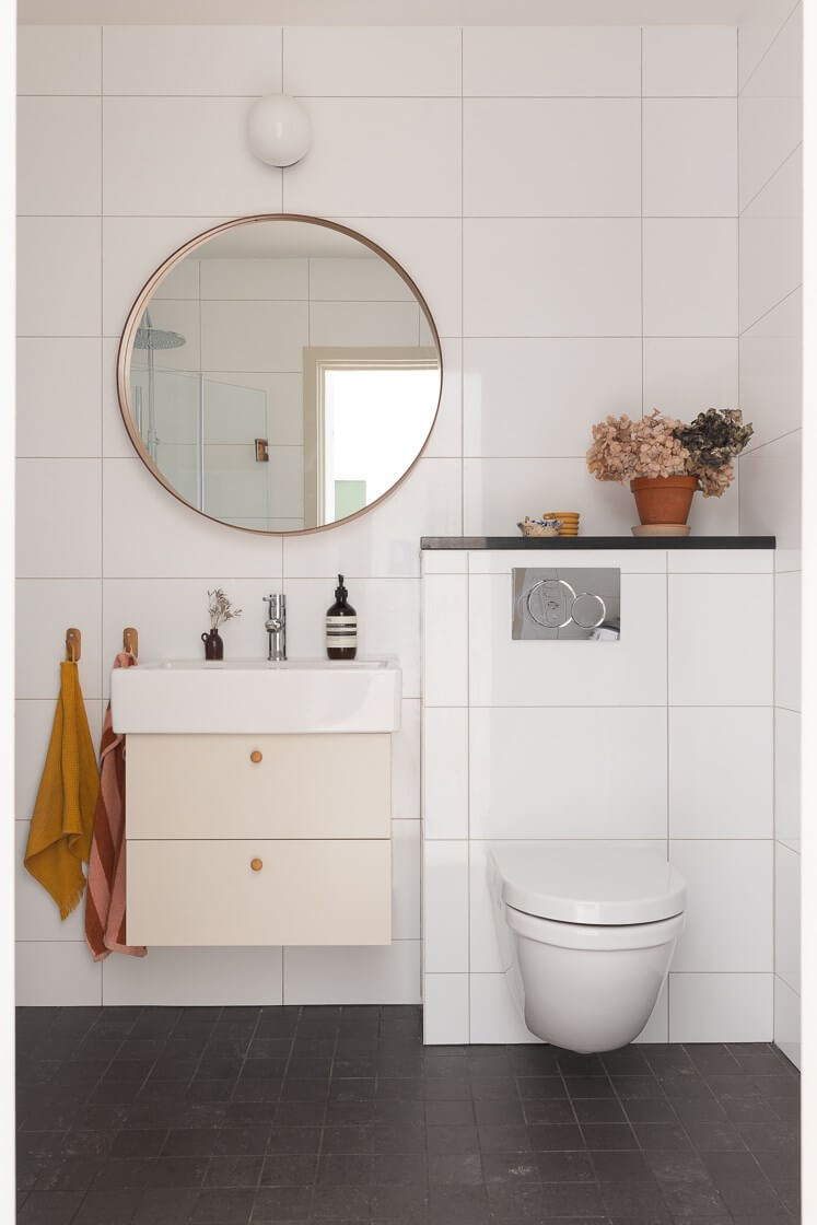Modern Interiors in a Bright 1930s Apartment in Sweden 34 bathroom large round mirror