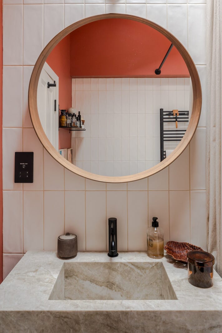 Cozy Contemporary Spaces in a Light-Filled Victorian Apartment 21 bathroom sink round mirror