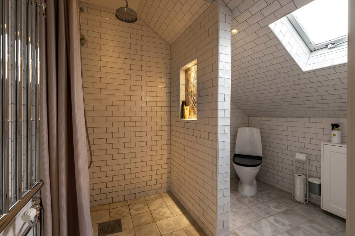 A Renovated 19th-Century Villa on Gotland 28 bathroom slanted ceiling white subway tiles