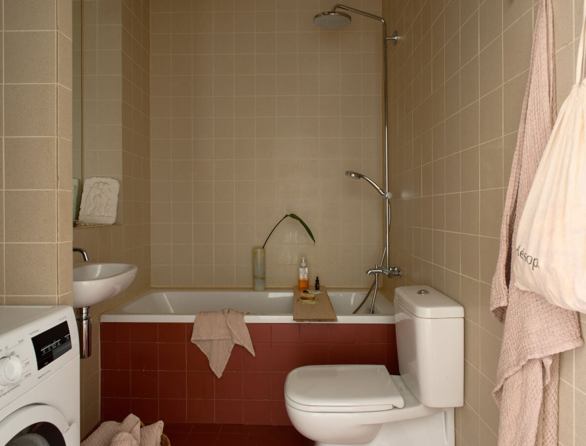 High Ceilings in a Small Swedish Loft Designed for a Family 18 bathroom terracotta colored tiles