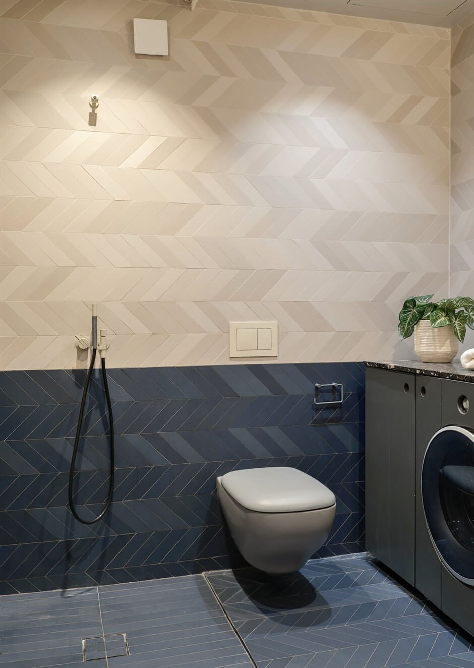 A Small Modern Stockholm Apartment with Smart Storage Solutions 19 bathroom two tone tile work chevron pattern