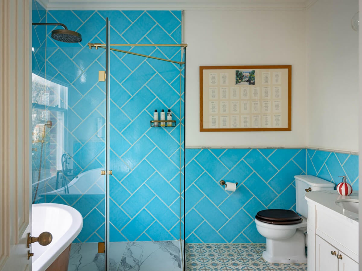 An Extended Family Home in London with Pink Crittall Doors 11 bathroom vibrant blue tiles