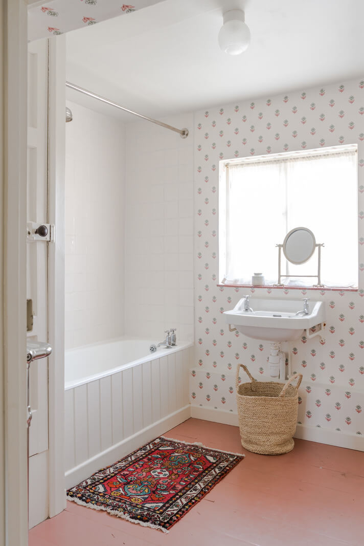 A Carefully Selected Color Palette in an 18th-Century English Cottage 13 bathroom with floral wallpaper and red floor