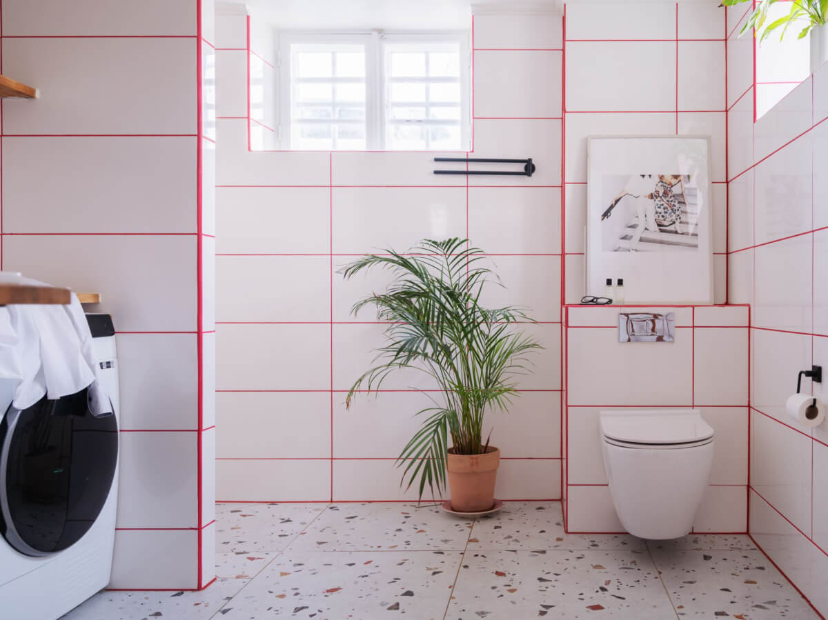 Painted Floorboards in a Unique Family Home in Sweden 32 bathroom with terrazzo floor tiles and red grout