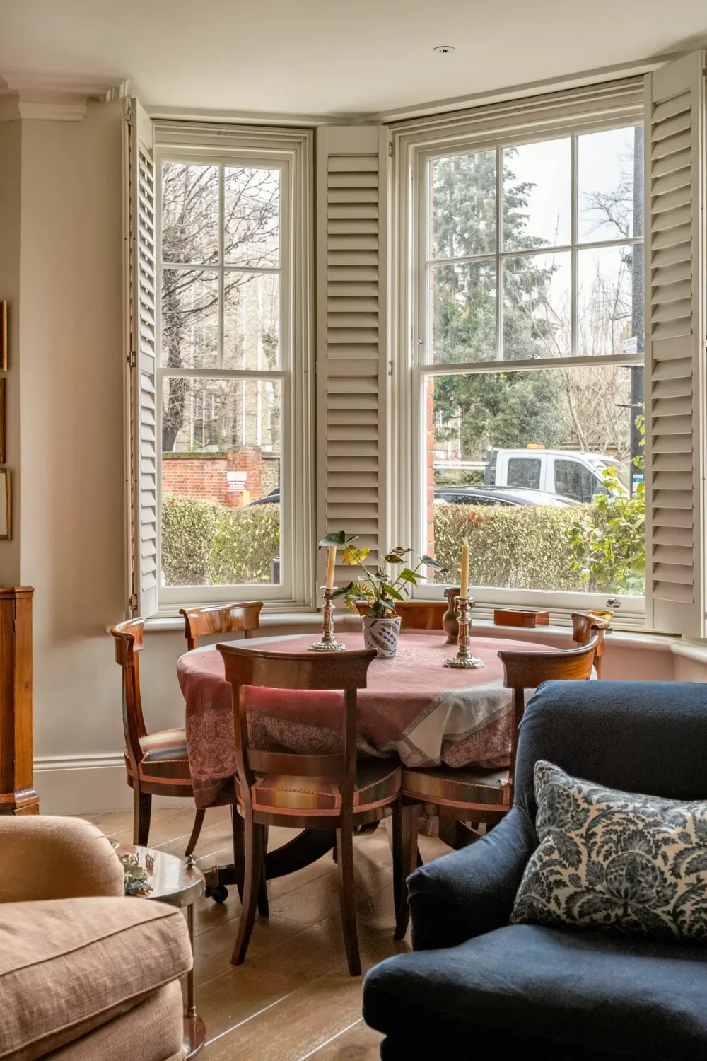 Classic Interiors and Antiques in an Art-Filled London Apartment 2 bay window round dining table