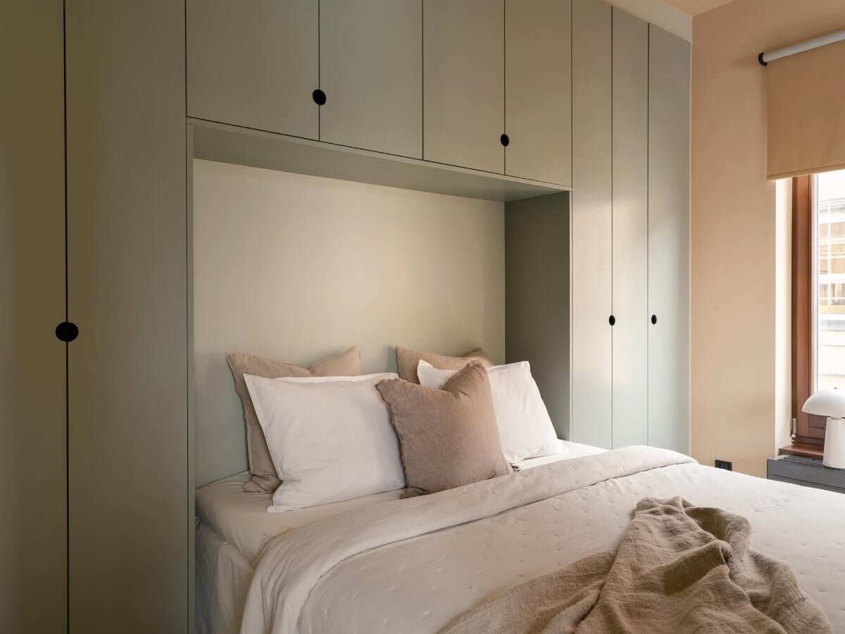 A Small Modern Stockholm Apartment with Smart Storage Solutions 7 bed surrounded by wardrobes