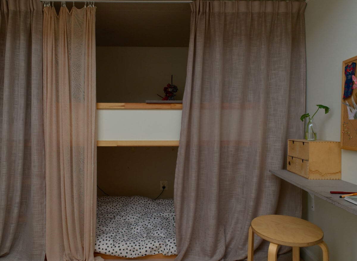 High Ceilings in a Small Swedish Loft Designed for a Family 15 bed with curtains