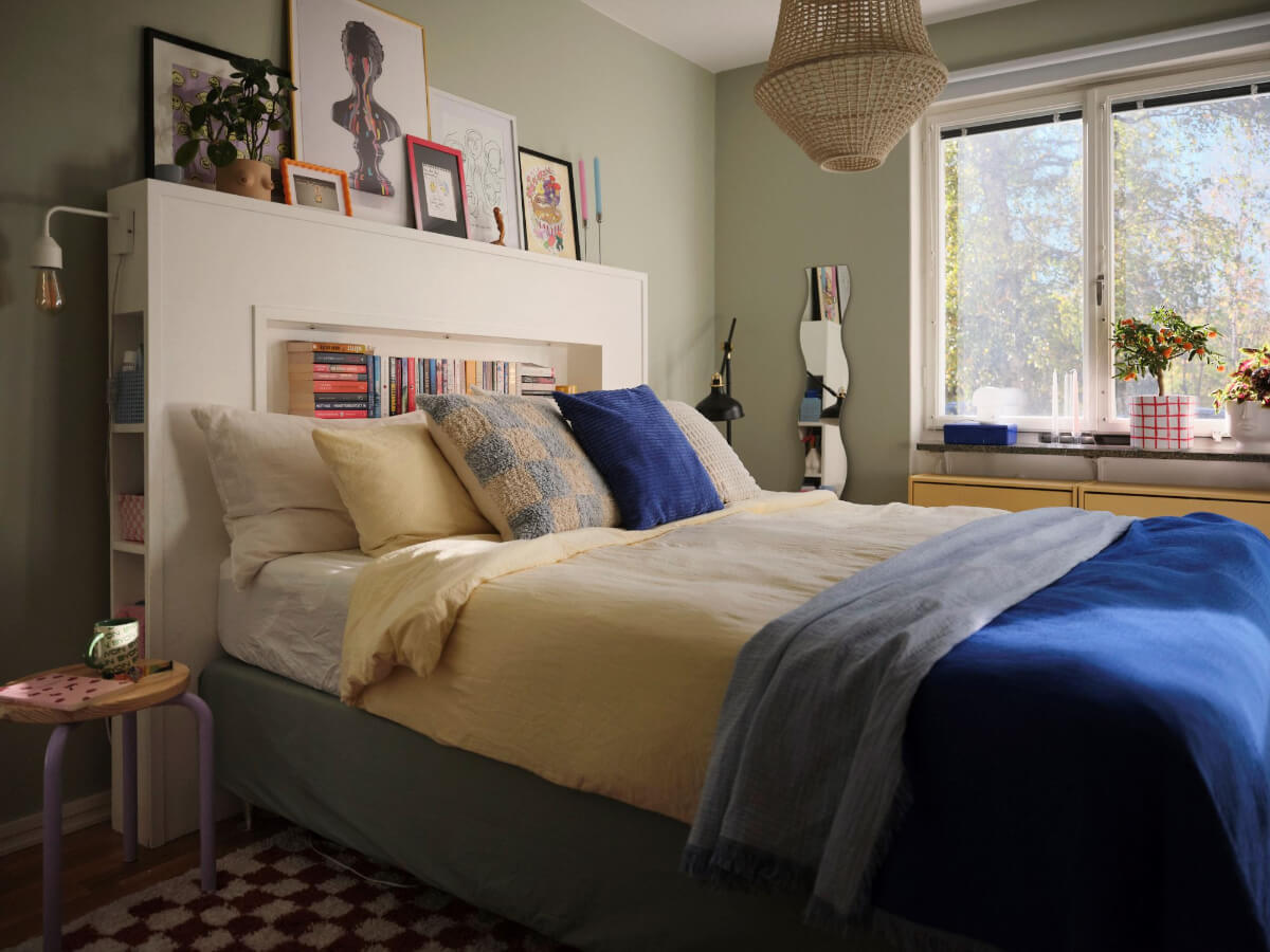 A Midcentury Swedish Apartment with Bright Color Accents 15 bedroom gray-green walls storage headboard