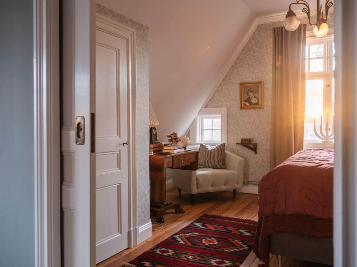A Beautiful Turn-of-the-Century Family Home in Sweden 37 bedroom slanted ceiling antique table