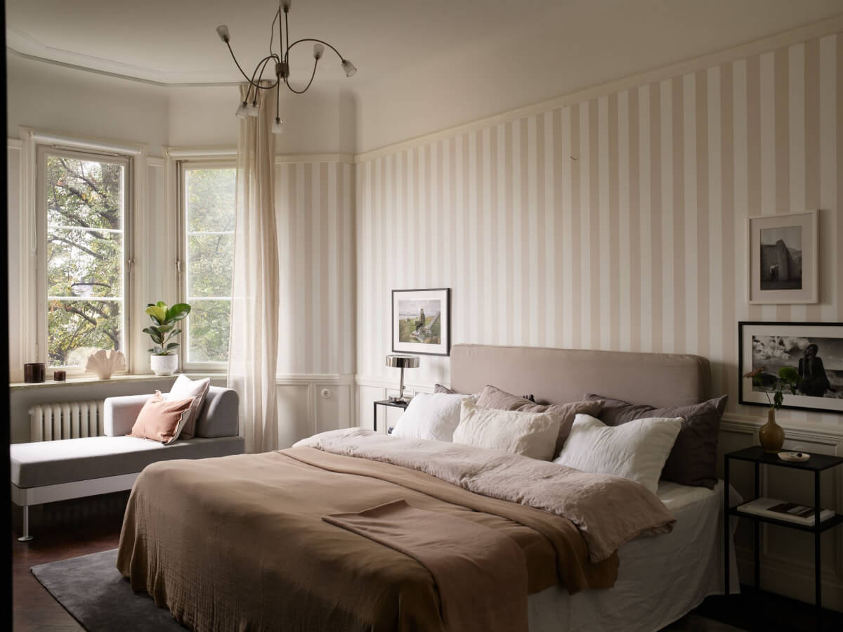 A Grand Early 20th-Century Apartment in Stockholm 19 bedroom striped wallpaper seat bay window