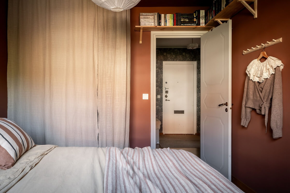 A Charming Apartment with Large Windows and Colorful Bedrooms 13 bedroom wardrobes behind curtain shelf above door