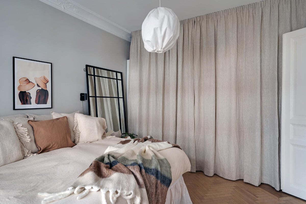 A Swedish Apartment with an Open Living Space and Period Features 24 bedroom wardrobes behind curtain