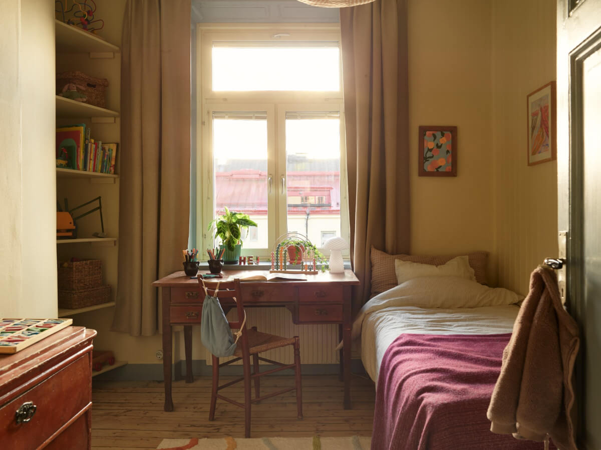 A Charming Historic Stockholm Apartment with a Blue Kitchen 25 bedroom with antique wooden desk and bookshelves