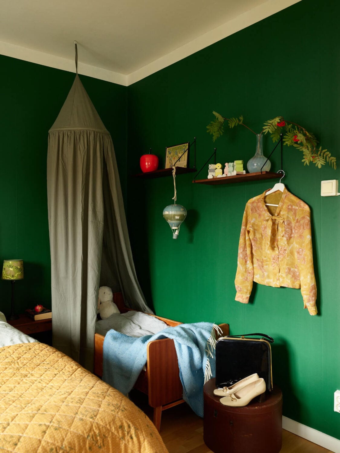 A Charming Midcentury Apartment with Original Features 20 bedroom with baby cot green walls